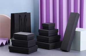 Collection of black kraft paper jewelry gift boxes and matching shopping bags in various sizes