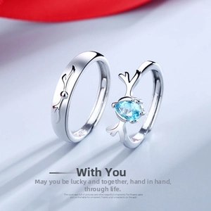 Detail of deer antler couple rings with blue teardrop gemstone and engraved silver band