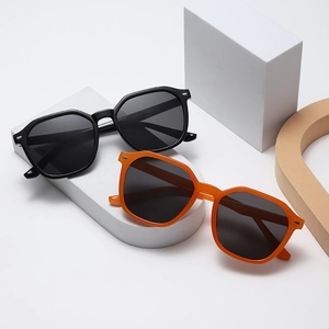 Fashionable oversized geometric sunglasses in black and orange with UV protection