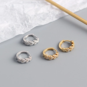 Detailed macro view of S925 sterling silver leaf hoop earrings with micro-set zircons