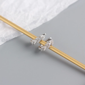 Detailed macro view of S925 sterling silver leaf earrings encrusted with sparkling crystals