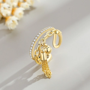 Gold layered open ring featuring zircon pave band and tassel pendant in vintage style