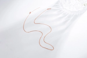 Detail of S925 rose gold adjustable chain with needle end for threading beads
