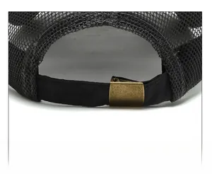 Detail of adjustable metal buckle and breathable mesh on the back of the black trucker hat