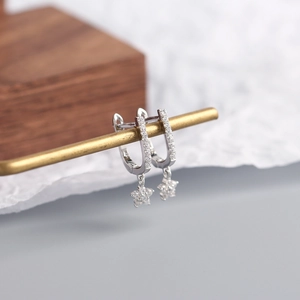 Detail of S925 sterling silver U-shaped earrings with sparkling star zircon pendants