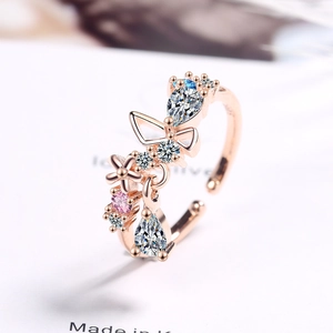 Elegant rose gold bow ring with pink and clear crystals in a minimalist open design