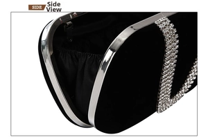 Detail view of the black velvet evening clutch showing silver rhinestone lettering and metal frame