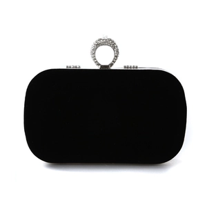 Elegant black velvet evening clutch bag with sparkling rhinestone ring handle and metal clasp