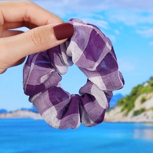 Detail of purple and white checkered organza scrunchie with soft pleated texture