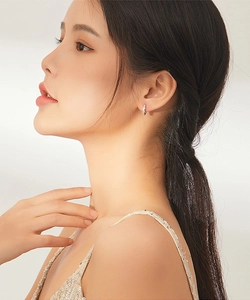 Minimalist 925 sterling silver infinity hoop earring shown on a model's ear