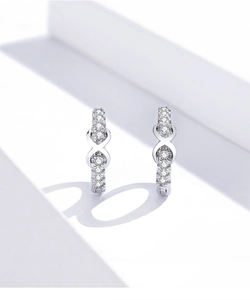 Macro detail of S925 sterling silver infinity hoop earrings with pave cubic zirconia