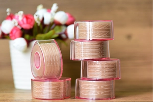 Flesh-colored lace eyelid tape rolls on transparent heart-shaped plastic bases