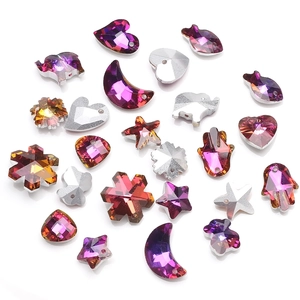 Detailed close-up of colorful faceted crystal charms in heart star and moon shapes