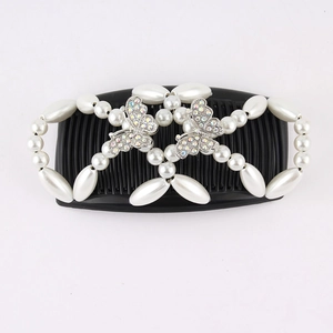 Detail view of black magic hair comb with white pearls and rhinestone butterflies