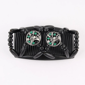 Detail of magic hair comb with green rhinestones and sturdy metal double-row prongs