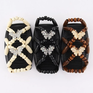Detailed view of elastic hair combs with wooden beads and butterfly accents in three colors