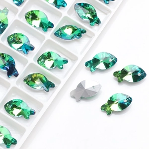 Macro detail of fish-shaped iridescent glass pendants for DIY jewelry making