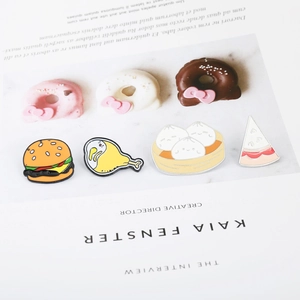Cartoon food enamel pins set featuring donuts and burgers on marble background