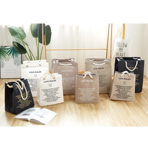 Large cotton canvas storage bags with rope handles in white, khaki, and navy blue
