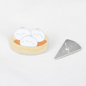 Detail of enamel baozi pins showing front cute design and back metal needle clasp