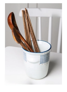 Detail of Japanese ceramic chopstick holder with blue stripes and large mouth design