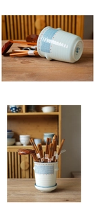 Detail of Japanese hand-painted ceramic chopstick holder with blue stripes and red dots