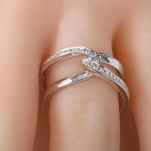 Modern double-layer crossover knot ring in white gold plating with sparkling cubic zirconia