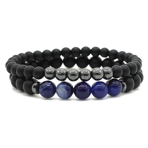 Two-piece beaded bracelet set with matte black stones, blue agate, and silver metal accents