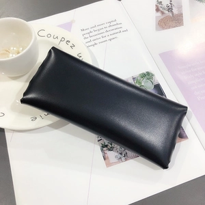 Minimalist black lychee texture leather eyewear case on elegant artistic white background