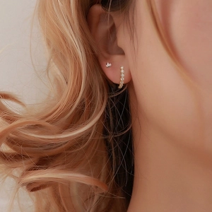 S925 silver marquise diamond crown and hoop earrings worn by a model in warm light
