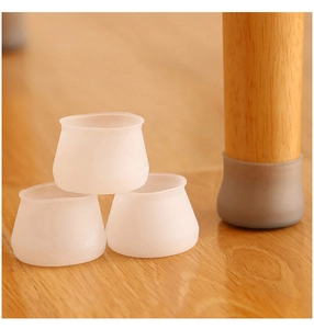 Close-up of gray silicone chair leg floor protector on a round wooden furniture foot