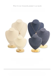 Detail view of portrait-shaped necklace display stands with solid beech wood round bases