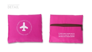 Detail view of pink 32L foldable travel bag showing front logo and back zipper pocket