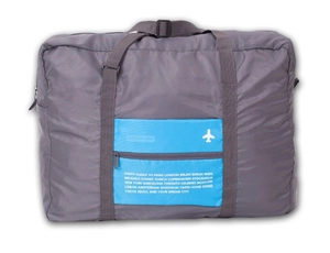 Detail view of foldable travel duffel bag with world city list and blue zipper pocket