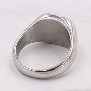 Macro shot of polished stainless steel ring showing inner texture and silver metallic luster