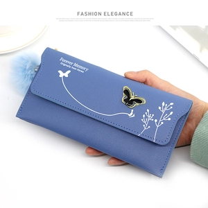 Blue faux leather long wallet detail showing butterfly buckle and soft pompom charm