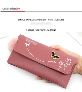 Detail of long pink wallet showing textured leather finish and 3D metal butterfly buckle