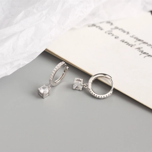 Close-up of S925 sterling silver geometric hoop earrings with square zircon pendant charms