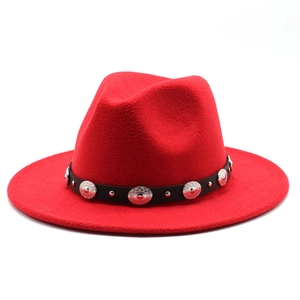Close-up of red felt fedora hat featuring a black belt with silver metallic studs