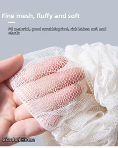 Close-up of high-density PE mesh texture and soft elastic layers of a white bath sponge