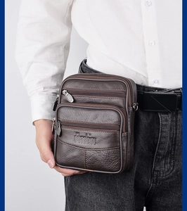 Detail of dark brown leather waist bag with multi-zipper and lychee texture for men
