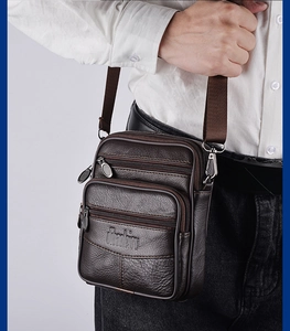 Detailed view of brown leather waist bag with three zip pockets worn by a model