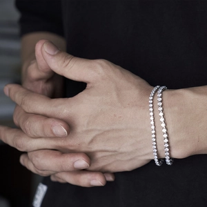 Hip-hop silver tennis bracelet with full diamonds set on wrist in a stylish lifestyle view