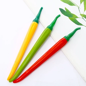 Detailed view of creative yellow, red and green chili pepper shaped gel pens on white books
