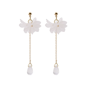 Detail of floral tassel earrings with white petals, gold chains and clear crystal drops
