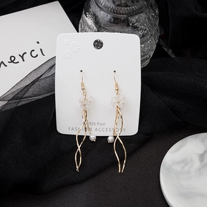 Detailed macro view of S925 silver needle floral earrings with white petals and pearls