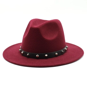 Close-up of deep red wool felt fedora featuring a black leather strap and silver studs