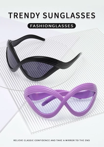 Detail of trendy cat-eye sunglasses with unique wavy textured frames in black and purple