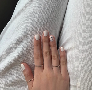 Close-up of minimalist 925 silver square thin rings worn in a stylish stacked way