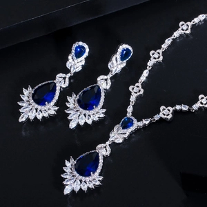 Detail of bridal jewelry set with pear-cut navy blue zircon gems and silver plating